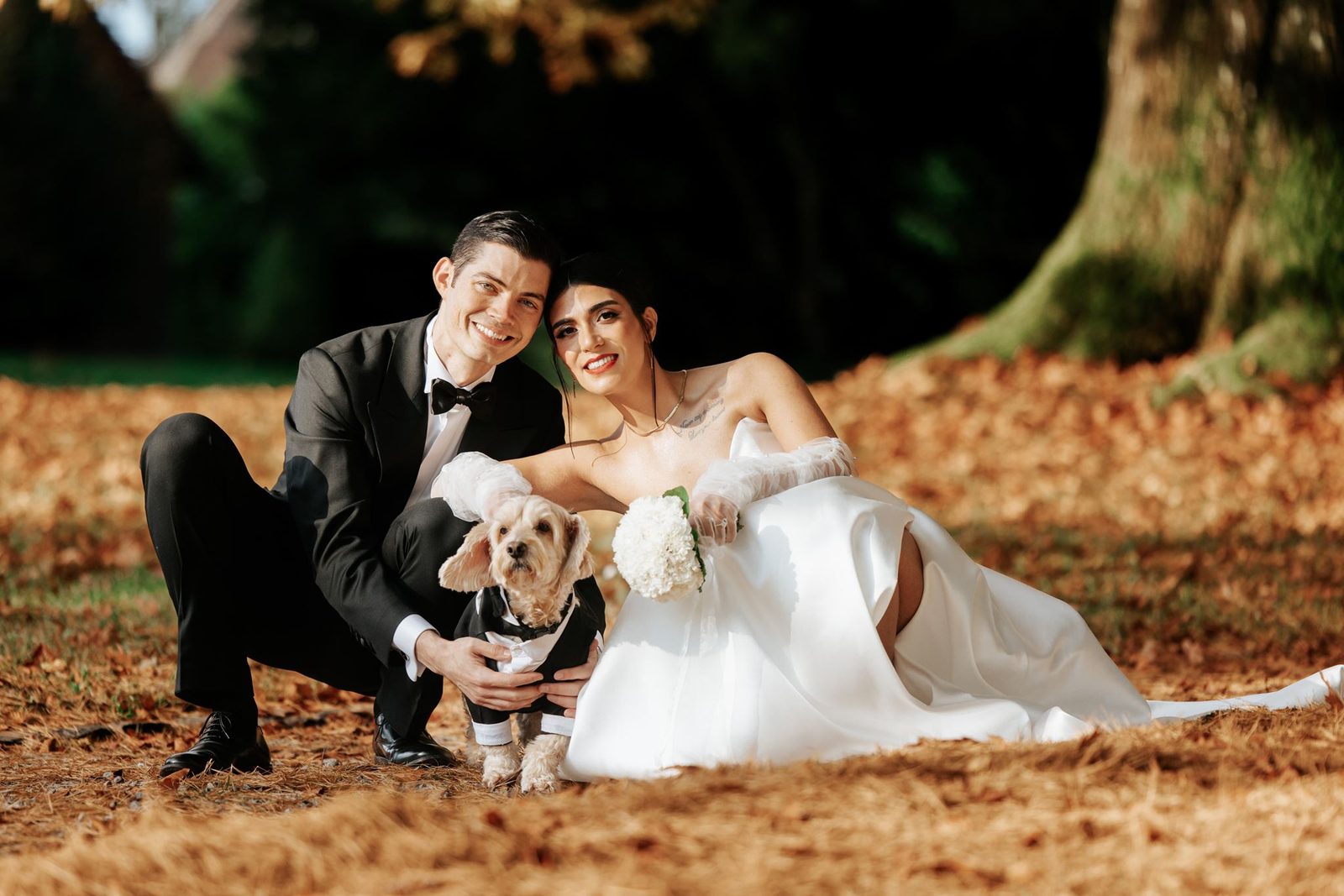 Persian bride and groom with their dog — autumn destination wedding portrait