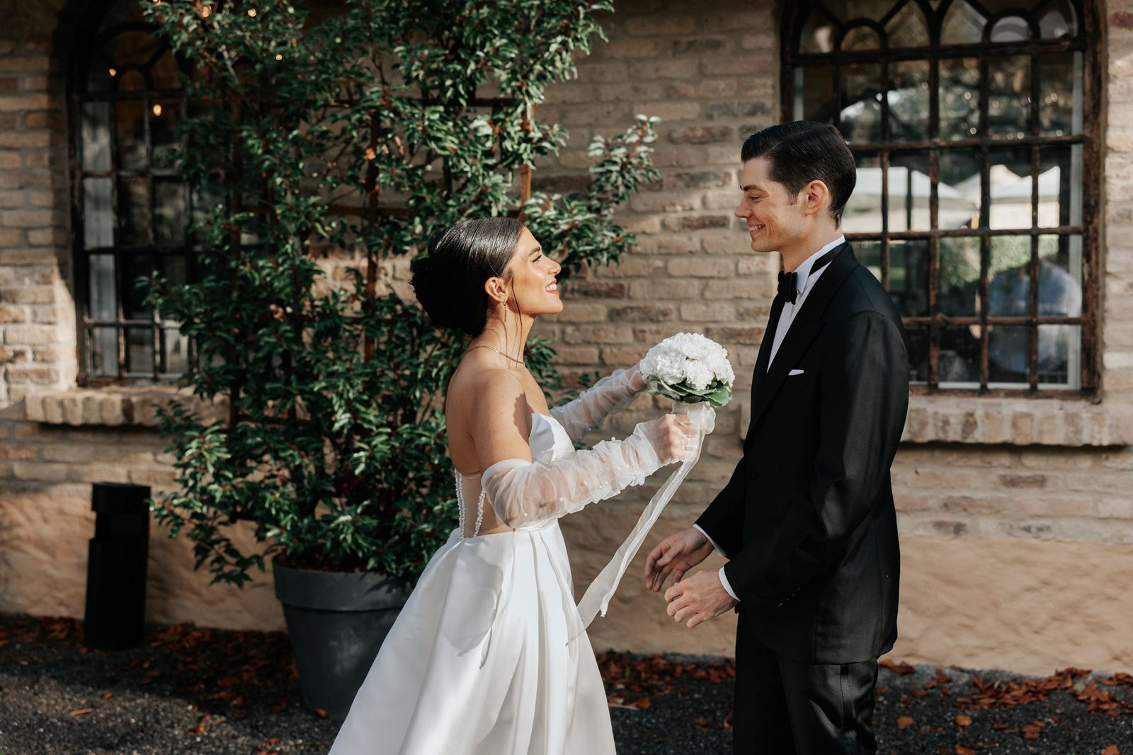Persian bride and groom embracing in front of a historic villa — destination wedding
