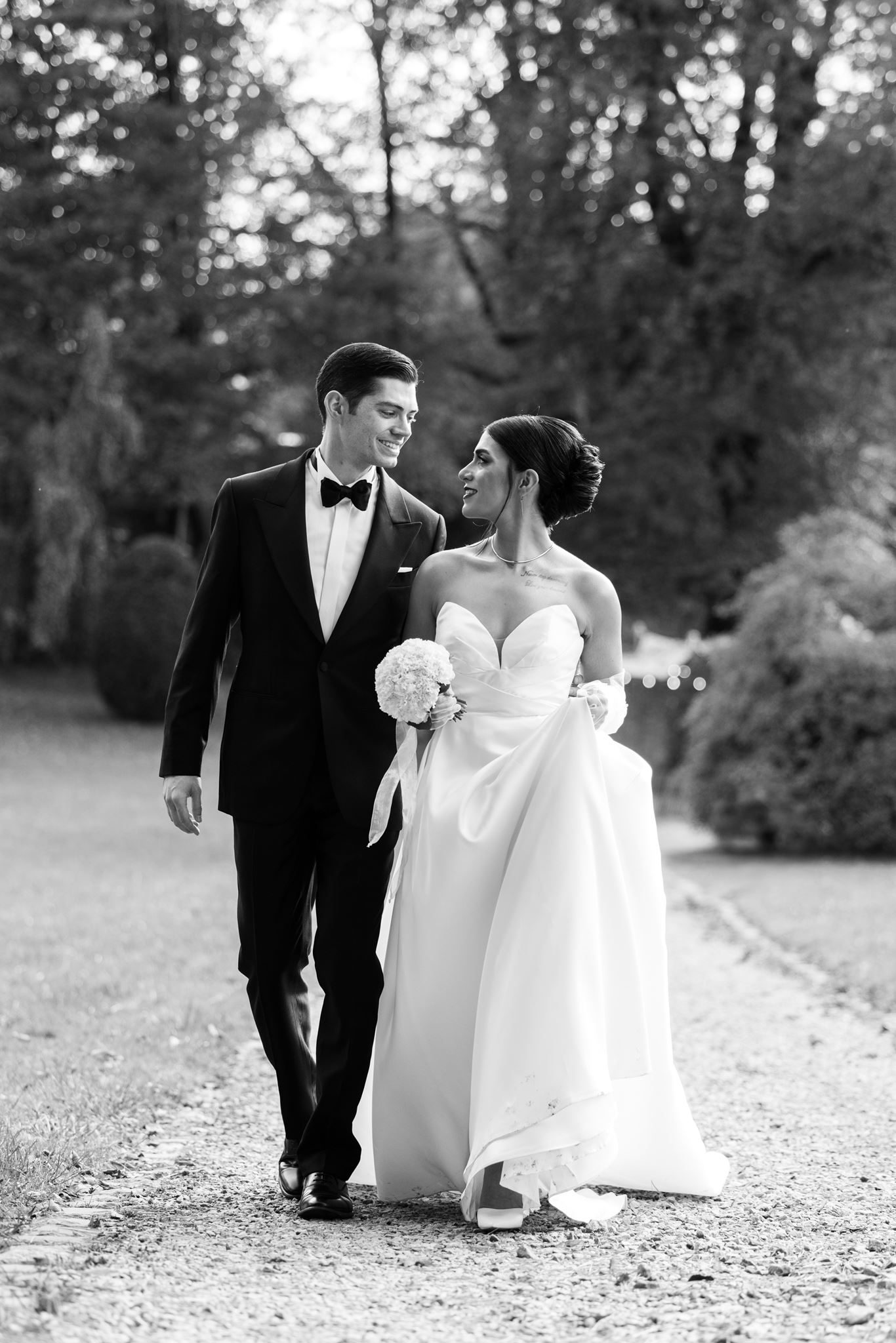 Persian bride and groom walking — black and white wedding portrait