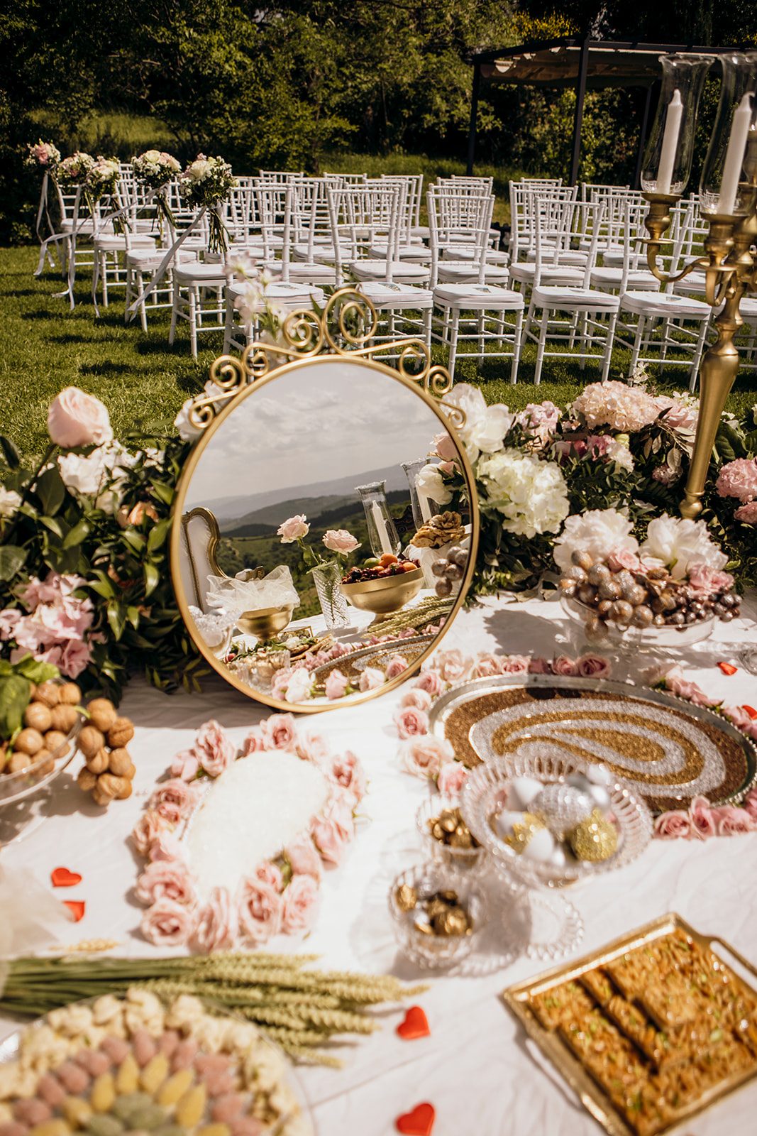Outdoor Sofreh Aghd with antique mirror, gold candelabras and pink florals