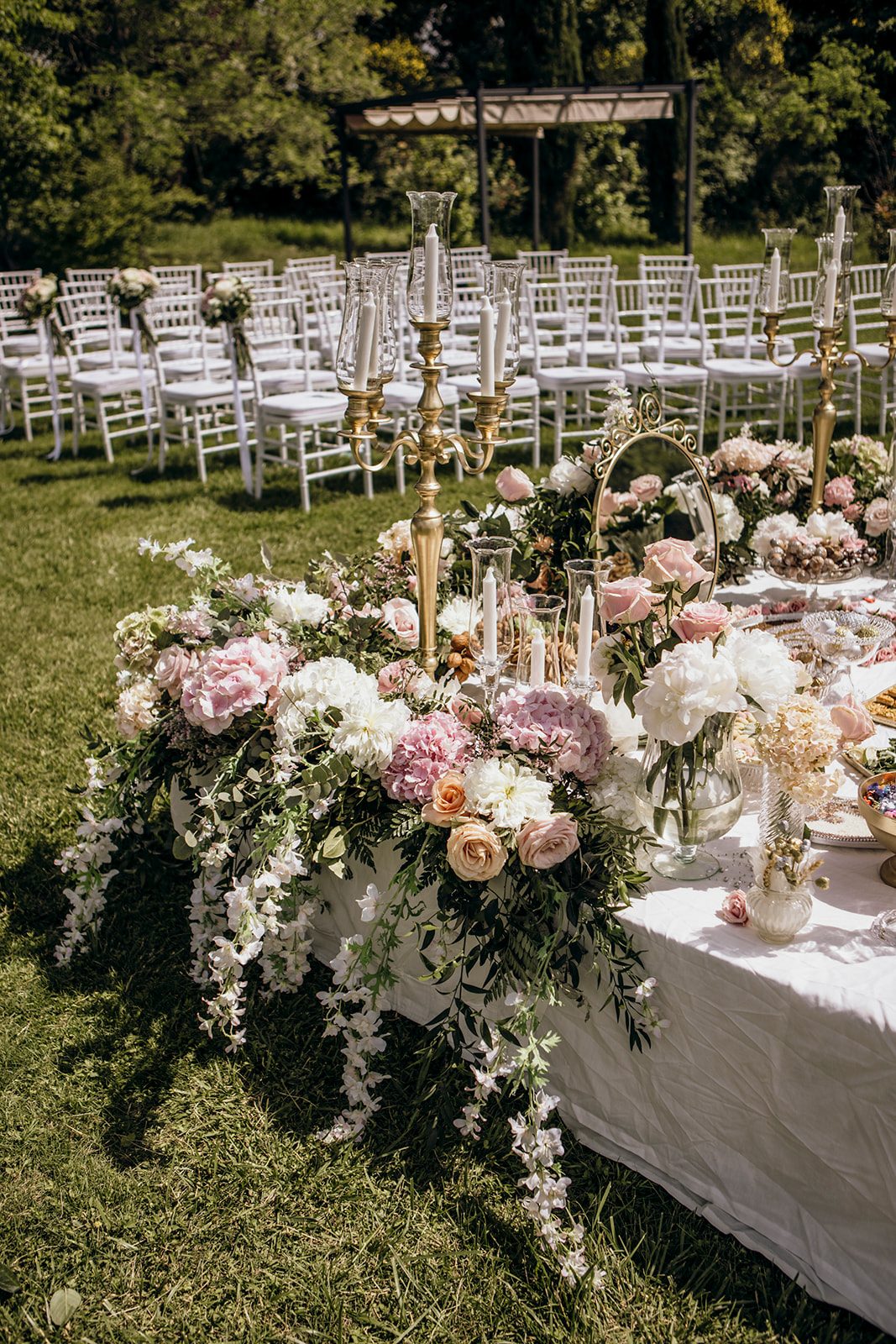 Outdoor Persian wedding Sofreh Aghd with pastel florals, candelabras and ceremonial styling