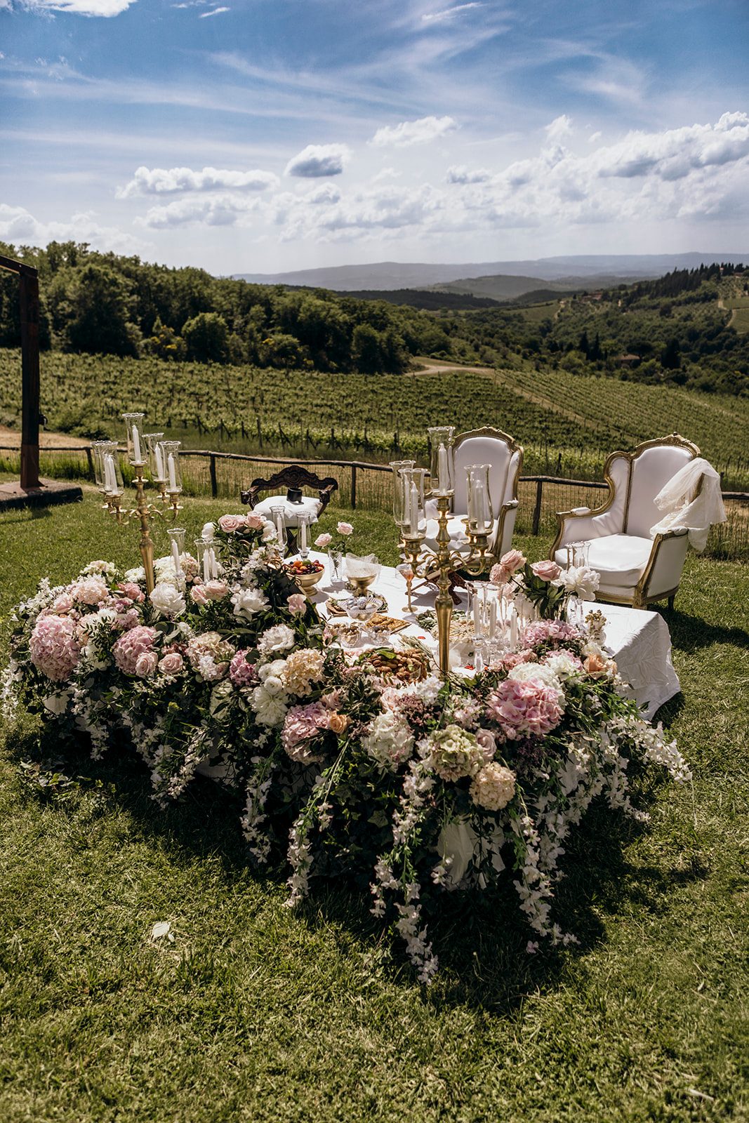 Sofreh Aghd in Tuscany — pink florals, gold candelabras and antique mirror overlooking a vineyard